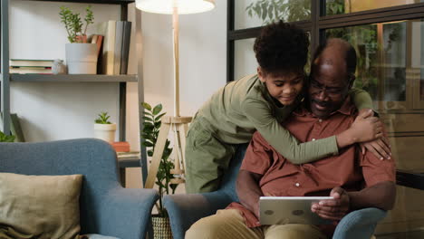 black man and boy in the living room