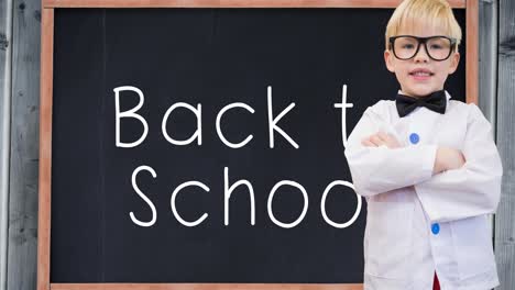 Animation-of-text-back-to-school-on-chalkboard-with-smiling-schoolboy
