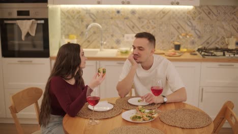 loving couple making a sandwich in kitchen-living room
