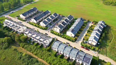 aerial view of residential houses neighborhood and apartment building complex at sunset