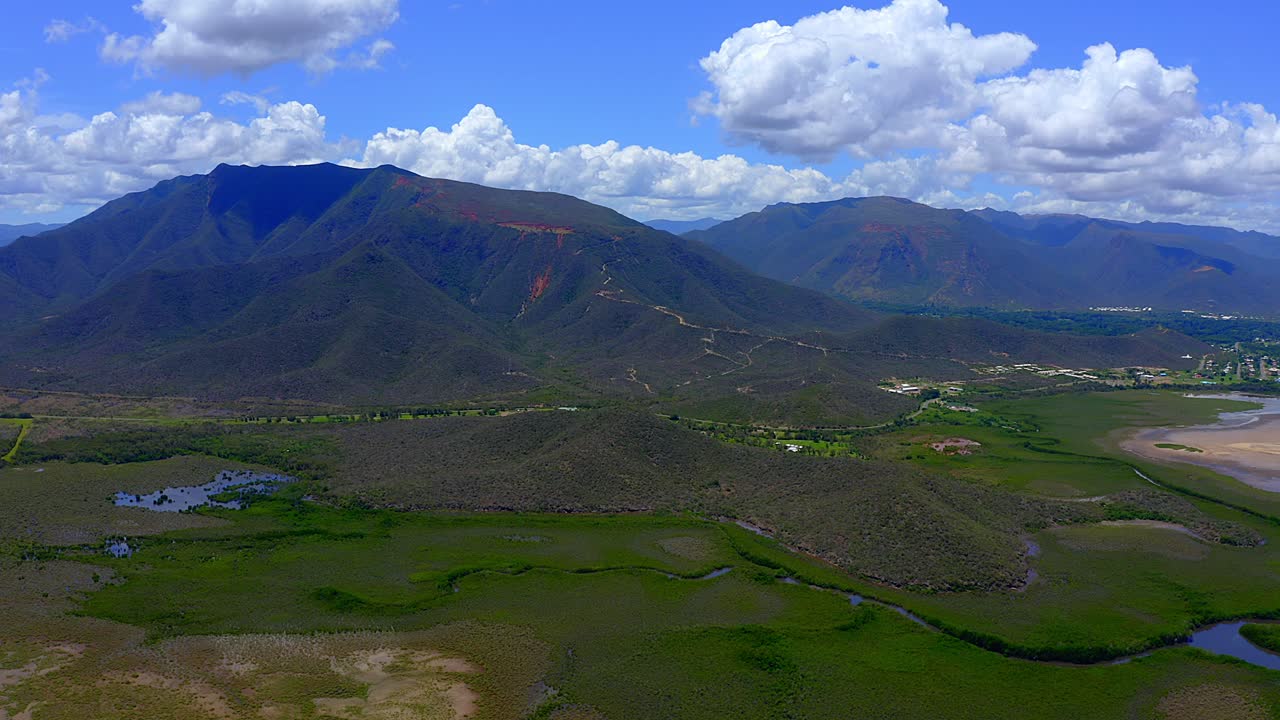 volar sobre un campo de manglares hacia algunas montañas durante un hermoso día