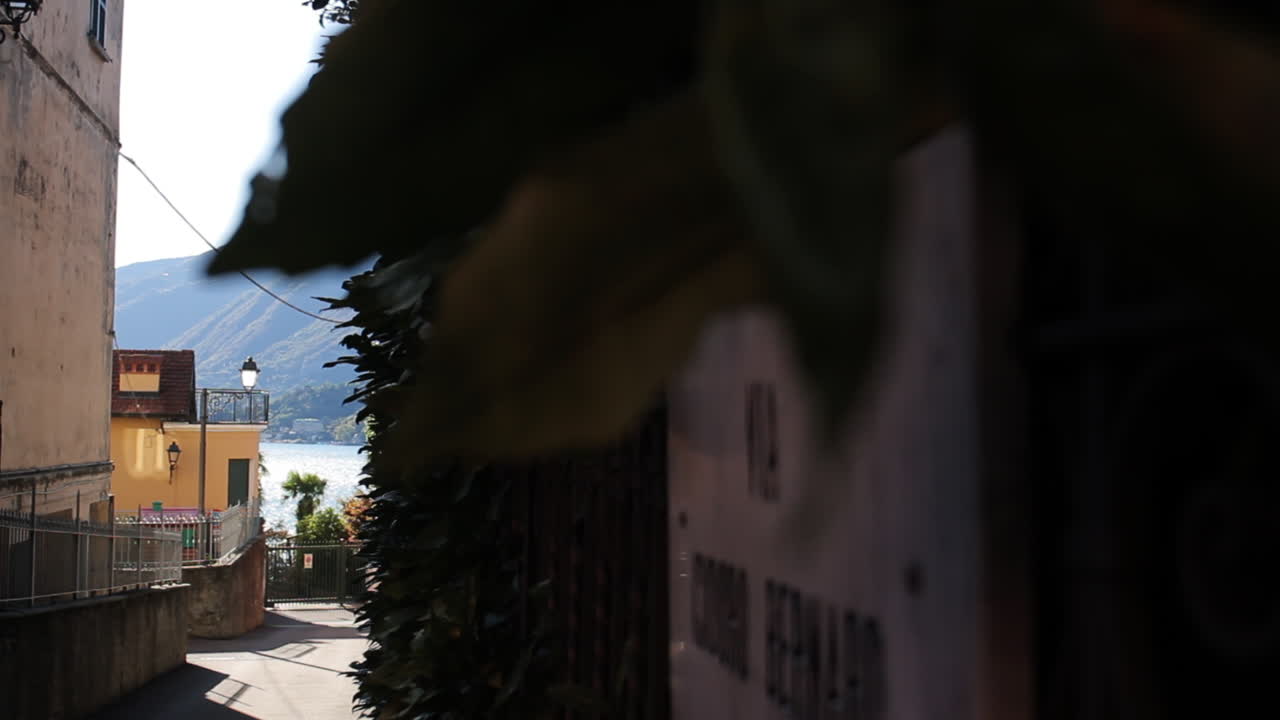 View of a street with lake and mountains in the background