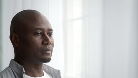 man looking out window