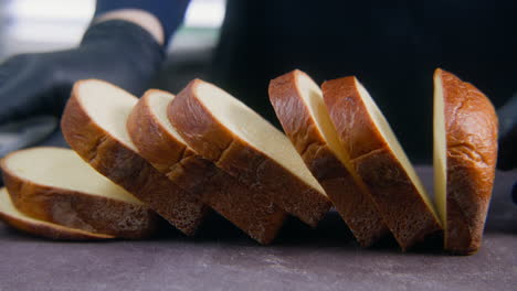 The-Cook-Cuts-Bread-for-Sandwich-or-Toast