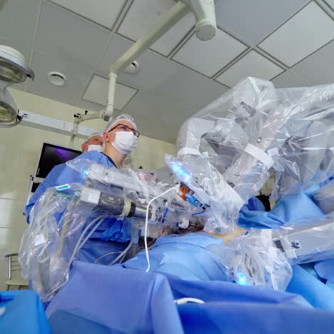 futuristic operation with medical robot. minimally invasive robotic surgery in clinic. new technologies in medicine. surgeon controls the work of robotic equipment