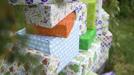 big pile of gift boxes colorful wrapped outside in birthday celebration