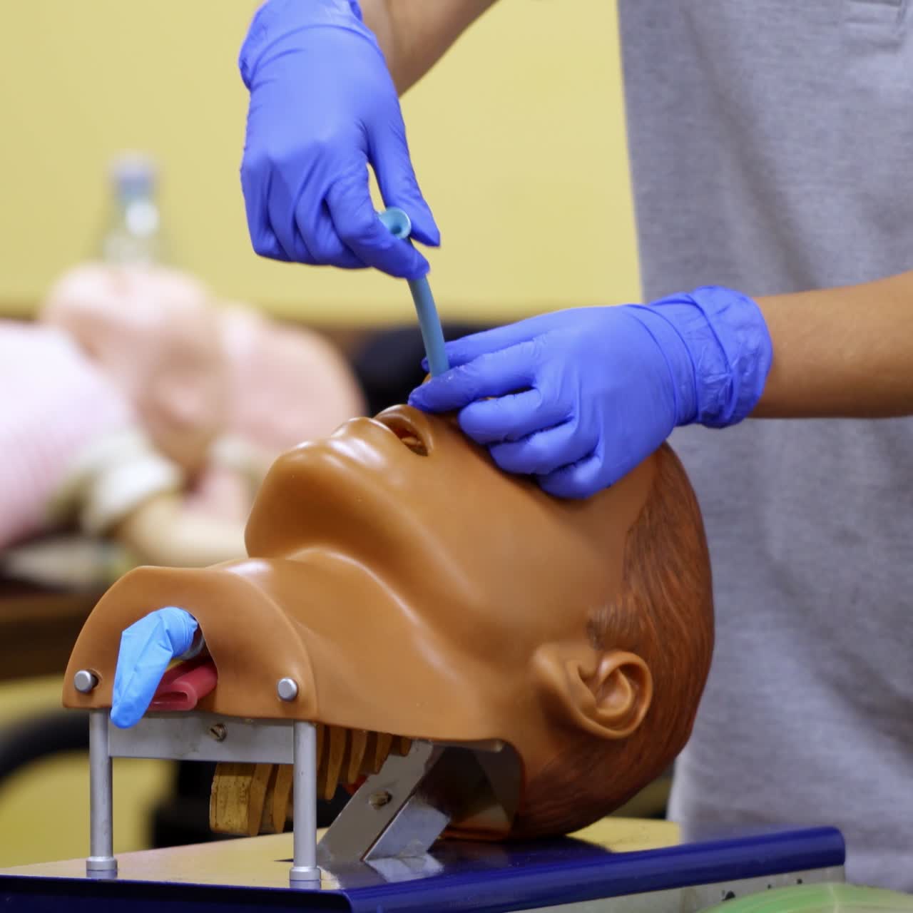Medic conducts medical teaching. Instructor teaching practical technologies on a dummy head in medical center
