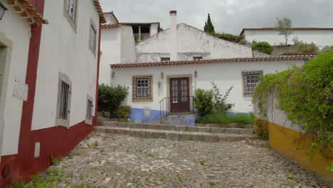 old ancient building in castle of óbidos that is surrounded with greenery