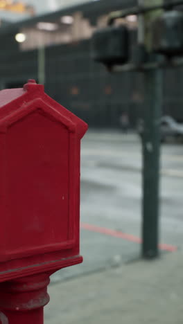 red fire alarm box on a city street