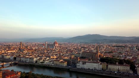 florence italy panorama with basilica of santa croce, duomo cathedral, palazzo vecchio and arno river, aerial lift pedestal shot