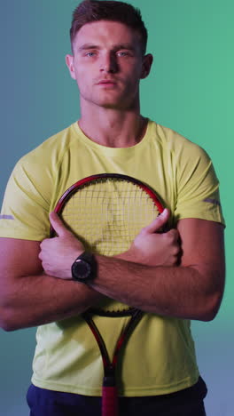 vertical video of portrait of caucasian male tennis player with tennis racket over pink lighting