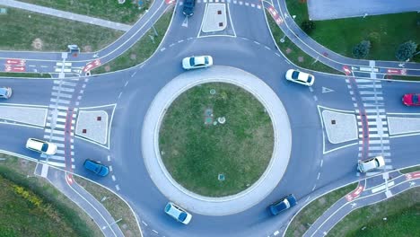 aerial rising shot of traffic in roundabout from birdseye