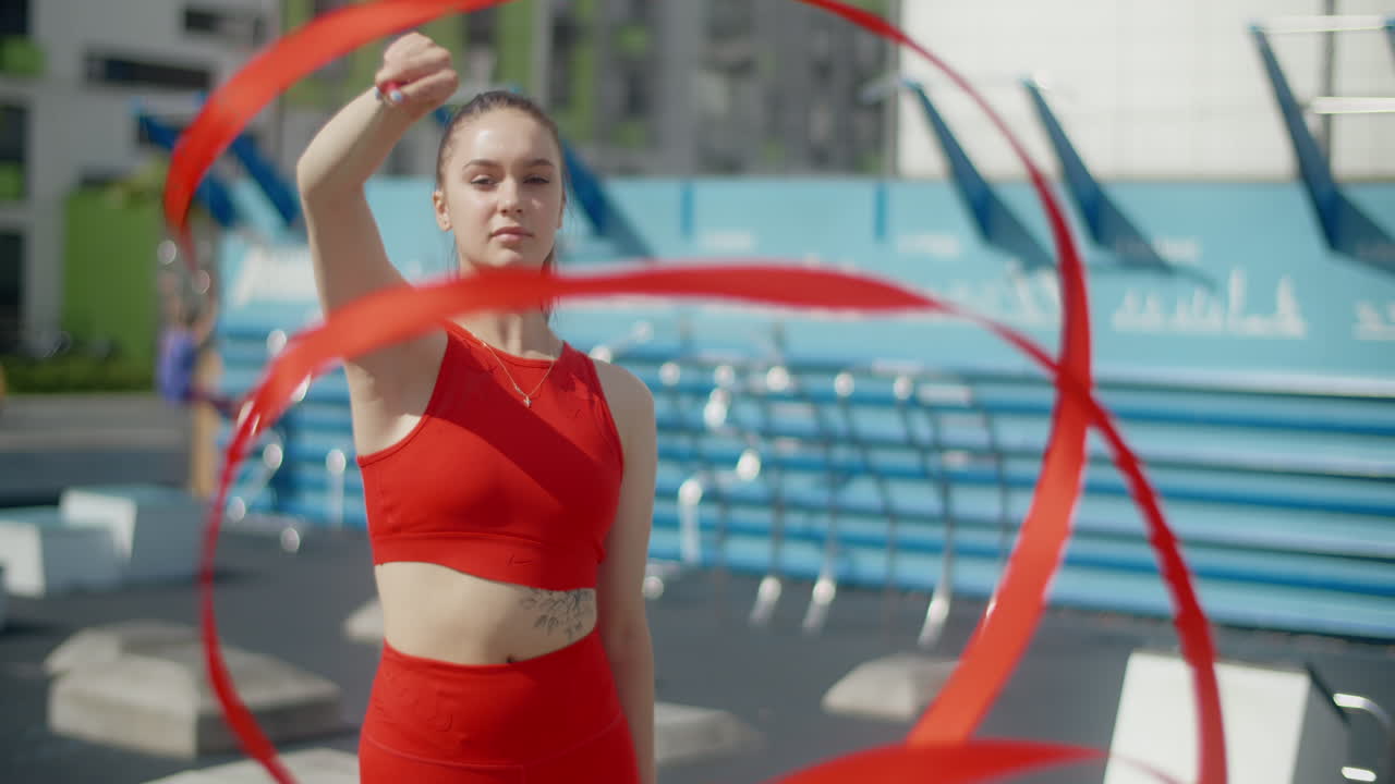 Woman performing ribbon dance outdoors