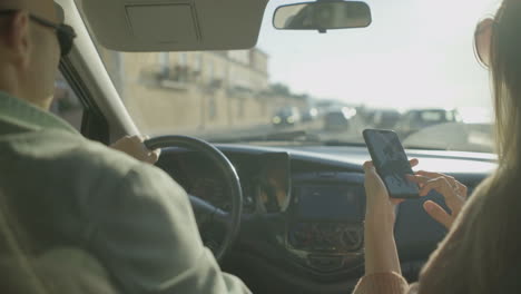 cropped shot of couple sitting inside car