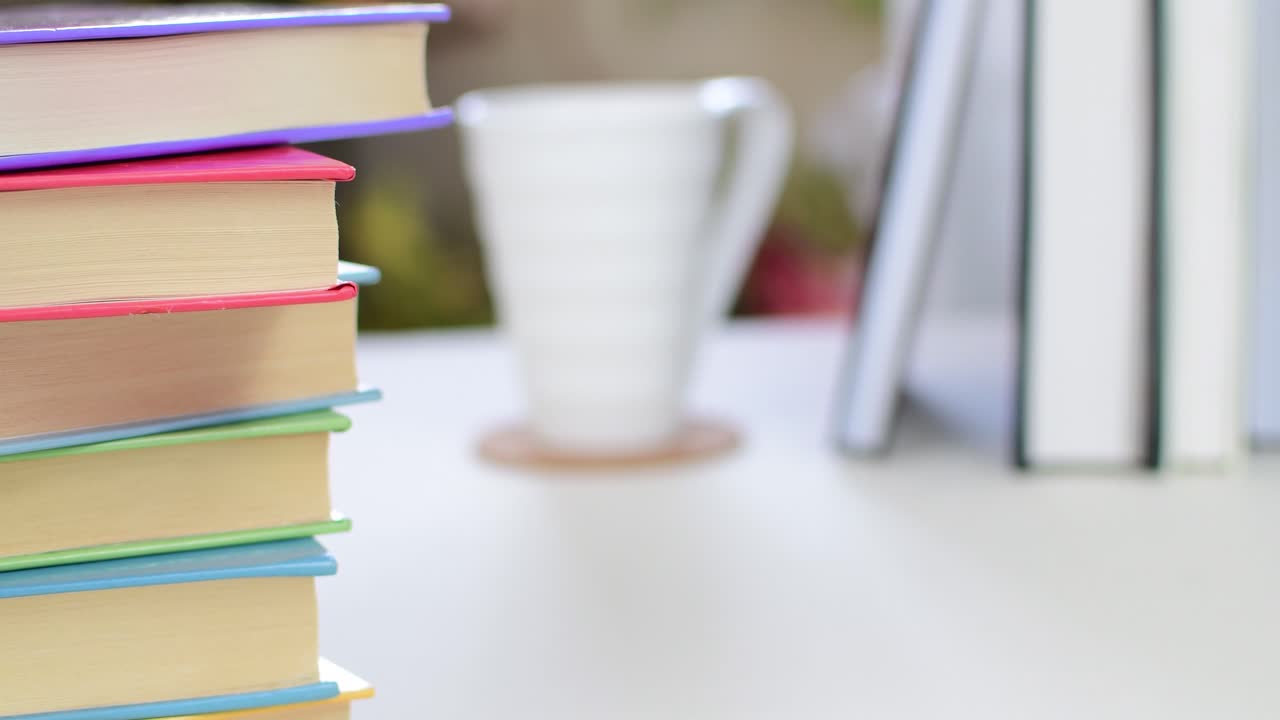 Desk with stack of study books. Textbooks for the student, university. Study from home. Distance education concept.