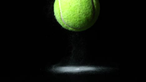 tennis ball falling on black background