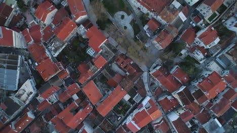 many red rooftops of split city in croatia with narrow streets, aerial top down shot