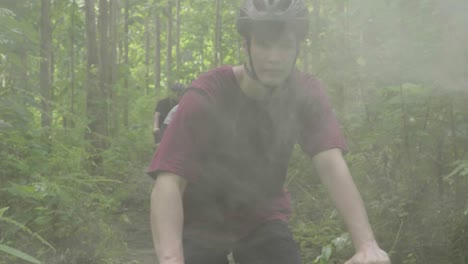 teenagers mountain biking in the forest