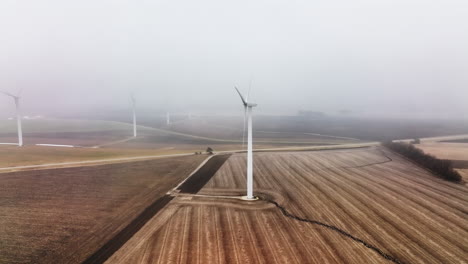 Aerial-shot-of-windmill-in-a-foggy-rural-setting