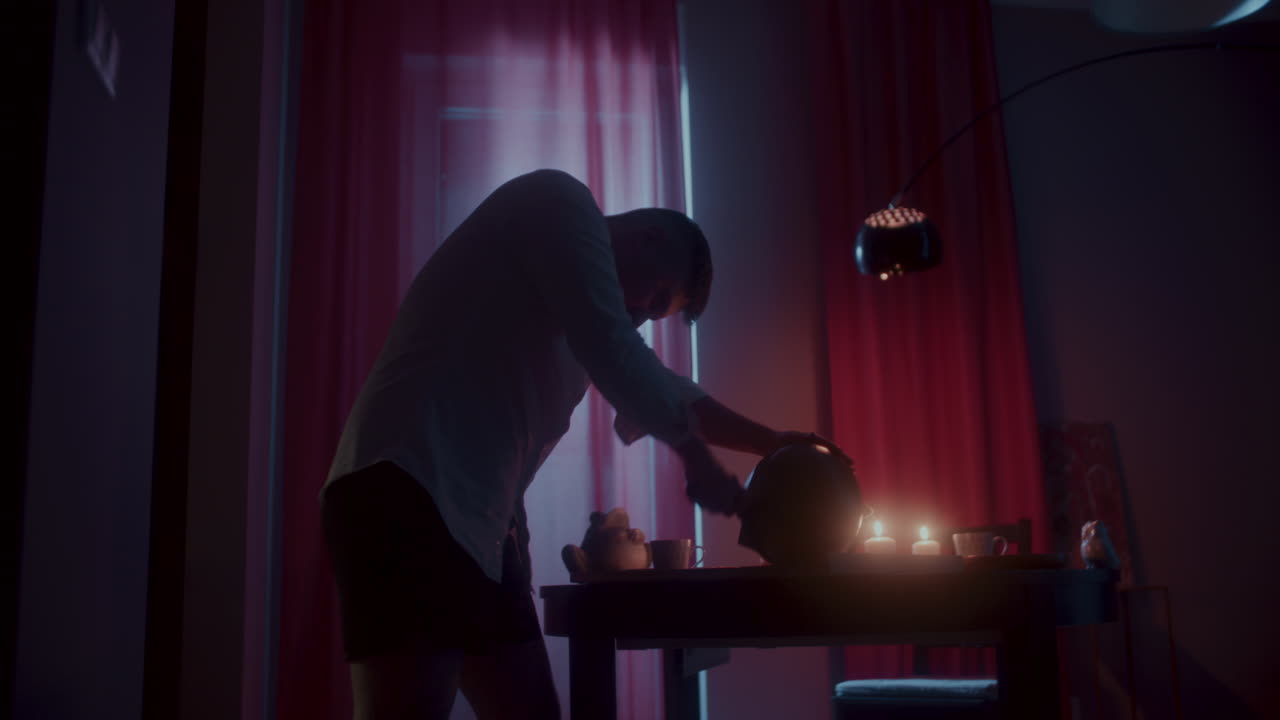 Man Preparing Tea at Night