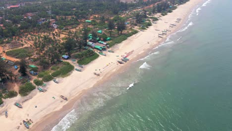 arambol goa beach drone shot orbital ships boats on empty beach bird's eye view