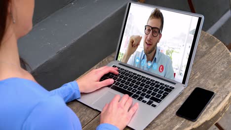 Caucasian-woman-using-laptop-on-video-call-with-male-colleague-working-from-home