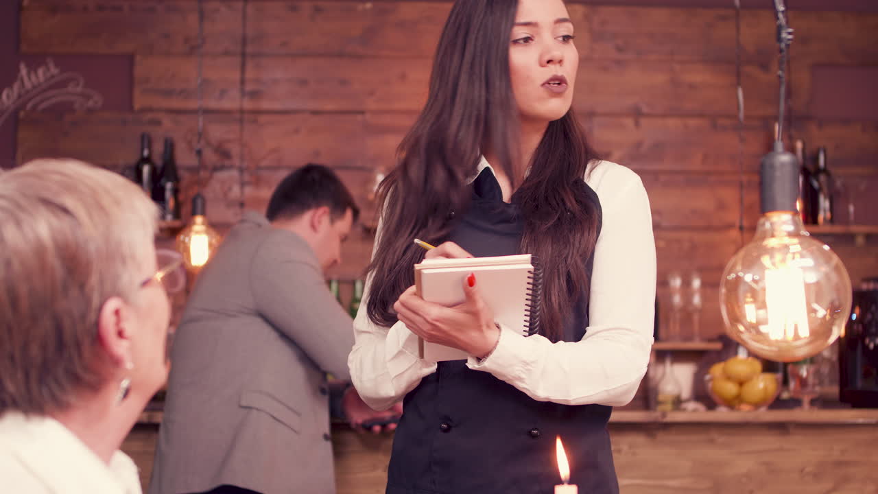 Waitress taking order from customer at restaurant