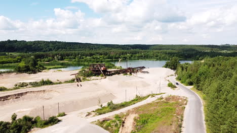 Sand-and-gravel-digging-site-with-industrial-equipment,-aerial-drone-view