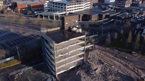 demolished multi storey car park concrete construction site development in town regeneration aerial right orbit