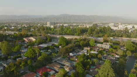 flying over north hollywood in san fernando valley, busy freeway with mountains on horizon