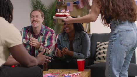 Woman-At-Home-Serving-Cupcakes-With-Miniature-American-Stars-And-Stripes-Flags-To-Friends-At-Party-Celebrating-4th-July-Independence-Day-4