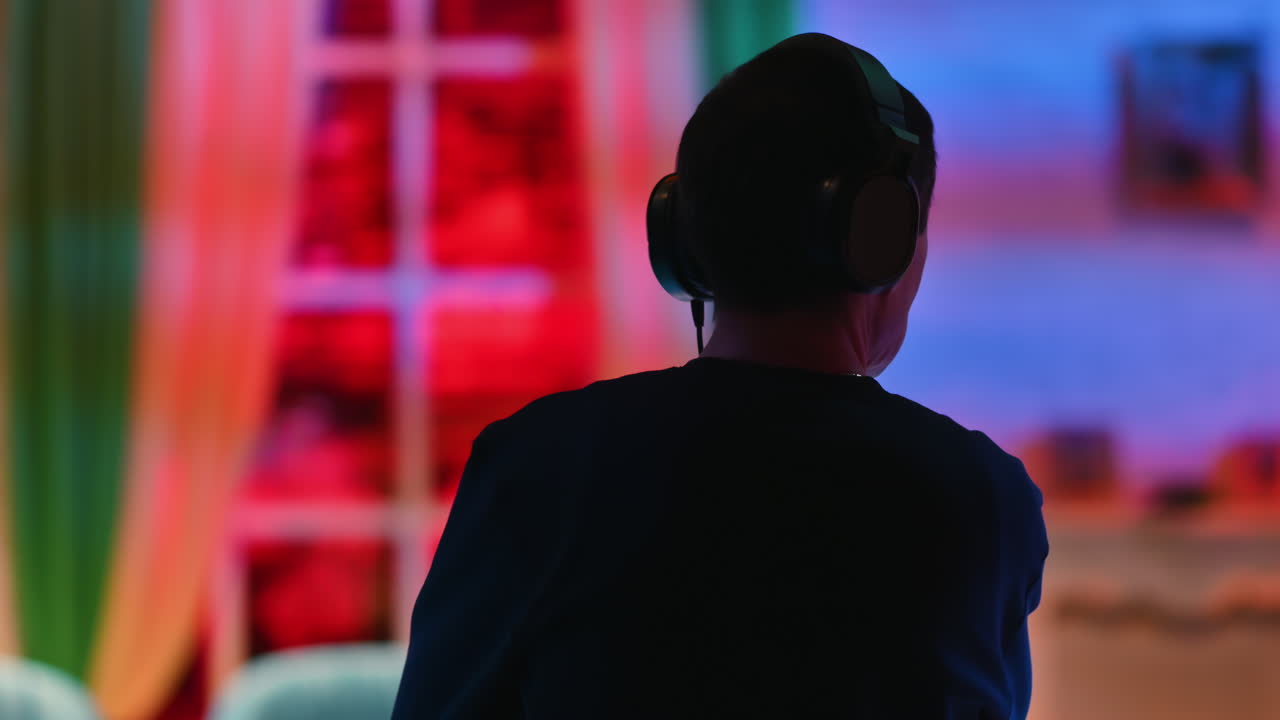 Silhouette of the director of photography with an audio headset in a television studio. Backstage of the preparation for the show