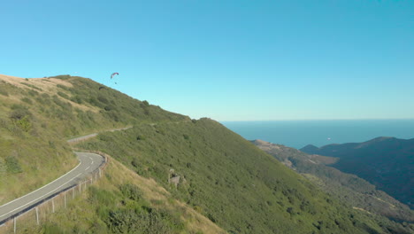 paraglider soars left, exits frame