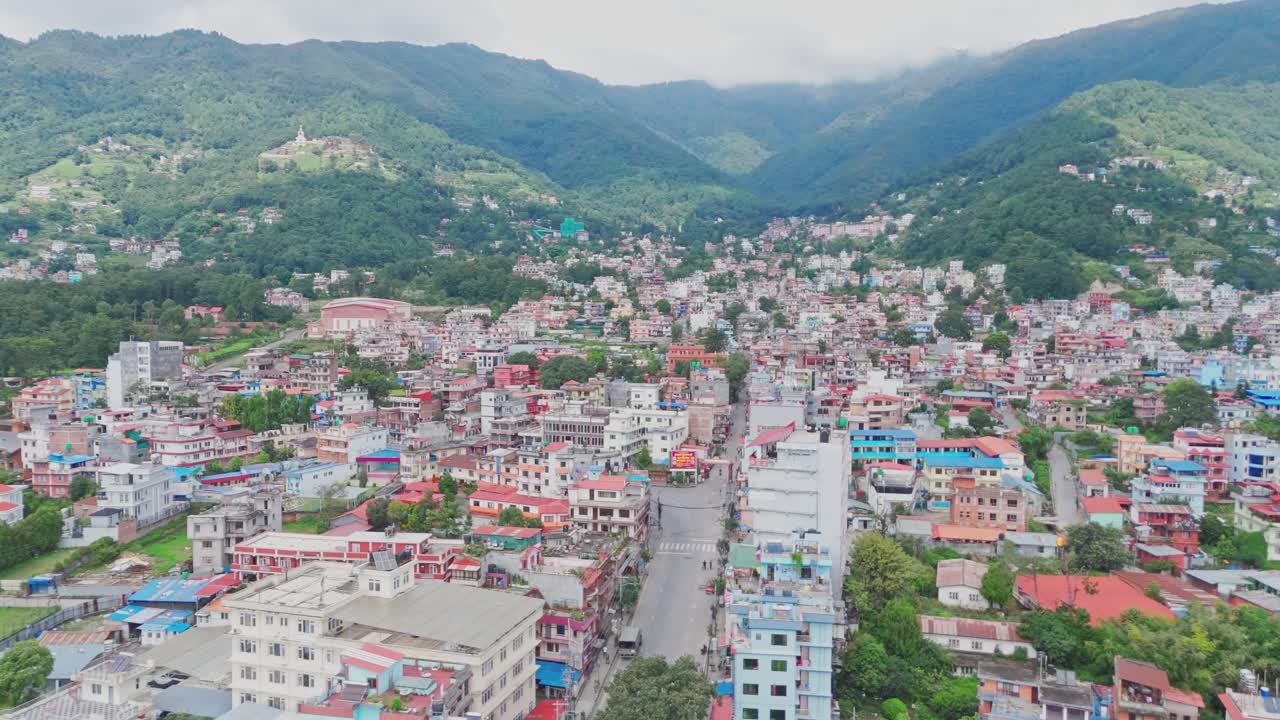 Aerial drone footage of Budhanilkantha in Kathmandu Valley, Nepal, showcasing city settlements, green hills, and scenic mountain landscapes from above