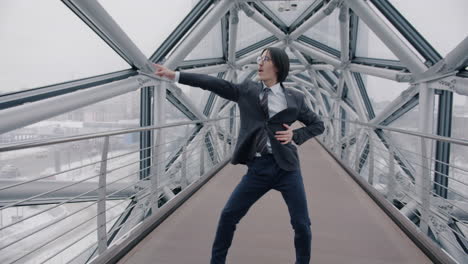 businessman dancing on a modern city bridge