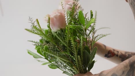 placing roses in an arrangement from a low angle