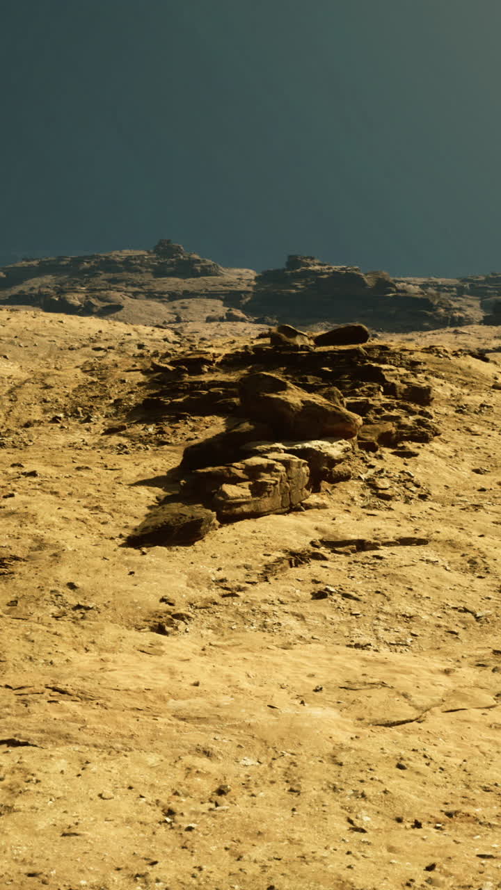 Unique rock formations and terrain in an arid landscape at sunset