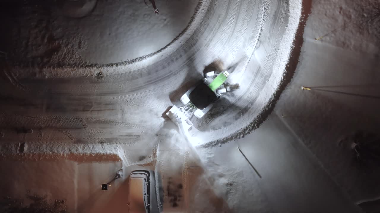 Snow plow machine operate outdoor Canada winter neighbourhood street at night