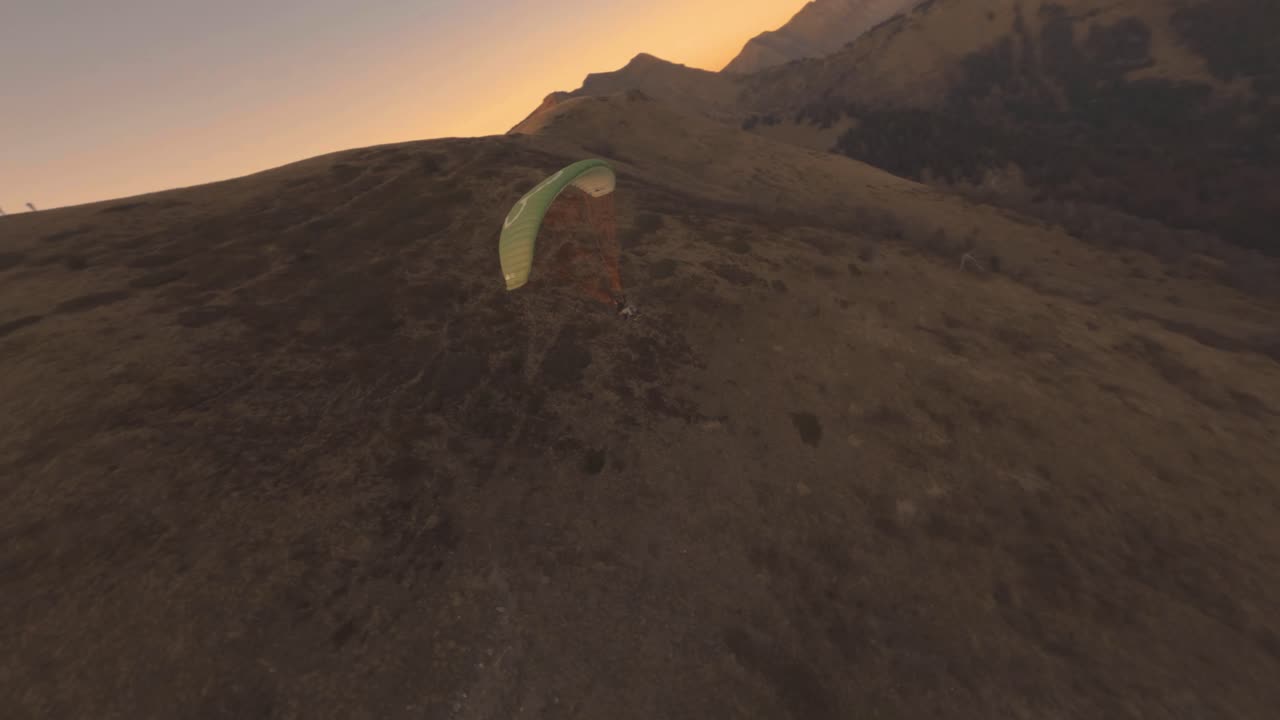 Paragliding in the Alps at Sunset