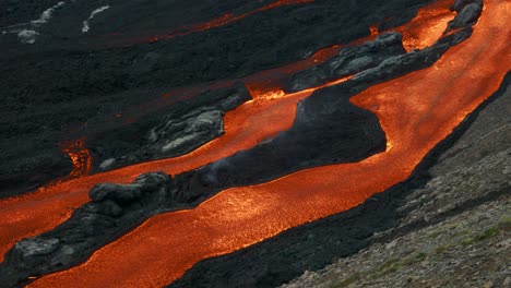 bright red flowing hot lava from the fagradalsfjall volcano in iceland