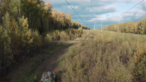 autumn forest road with power lines