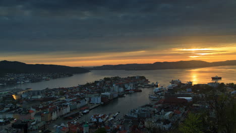 beautiful sunset in bergen, norway with amazing changes in color and the city lights coming on