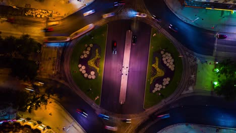 timelapse of night city traffic on 4-way stop street intersection circle roundabout in yekaterinburg city centre. 4k uhd horizontal aerial top view