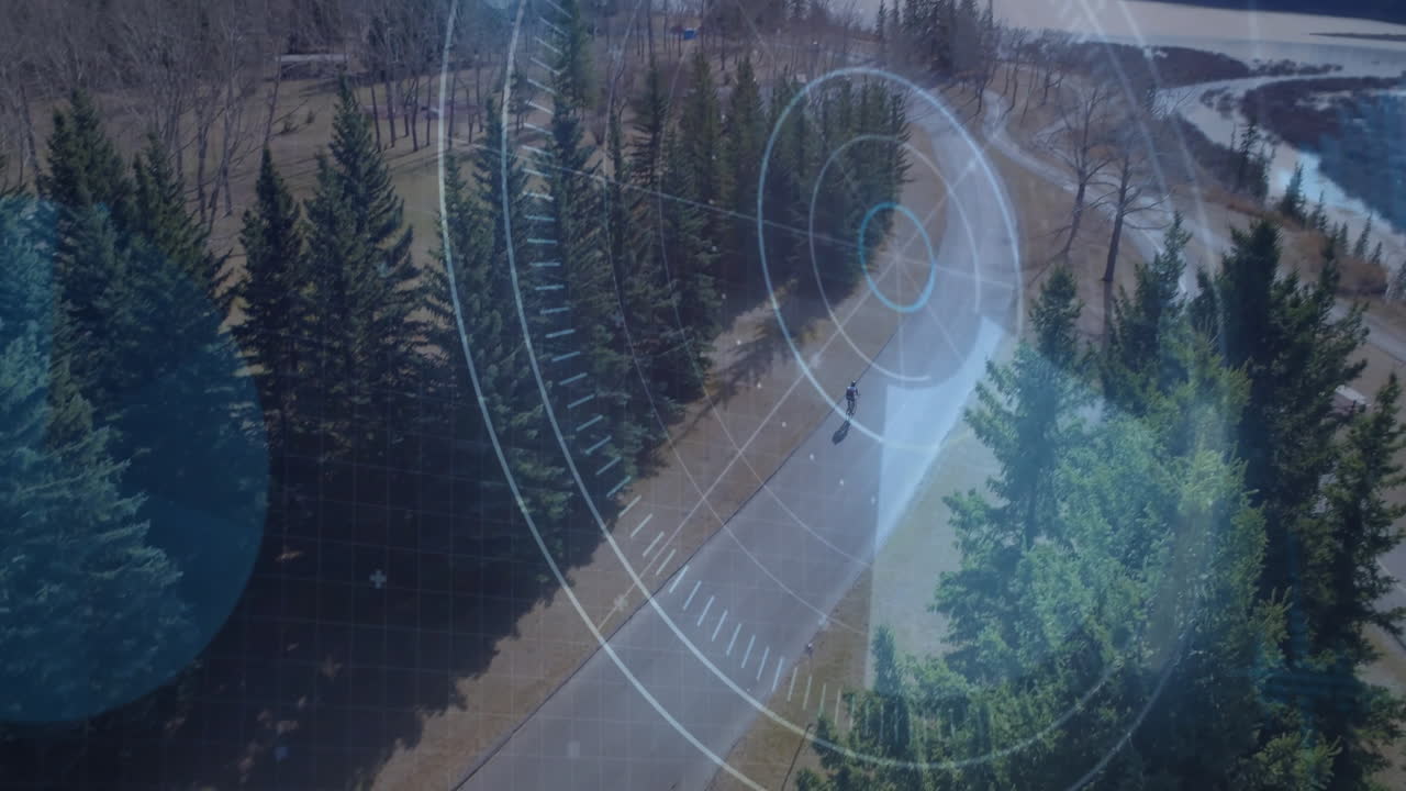 Teenage boy riding bike on winding forest road, showcasing technology HUD targets and grid overlay