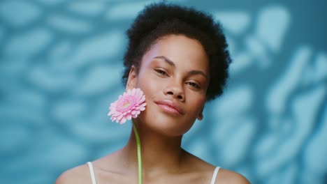 smiling woman with pink flower