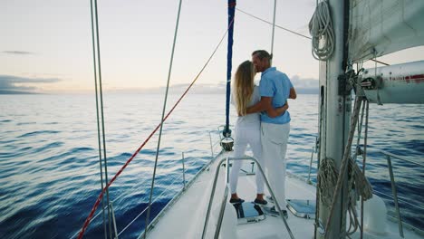 couple sailing on yacht at sunset