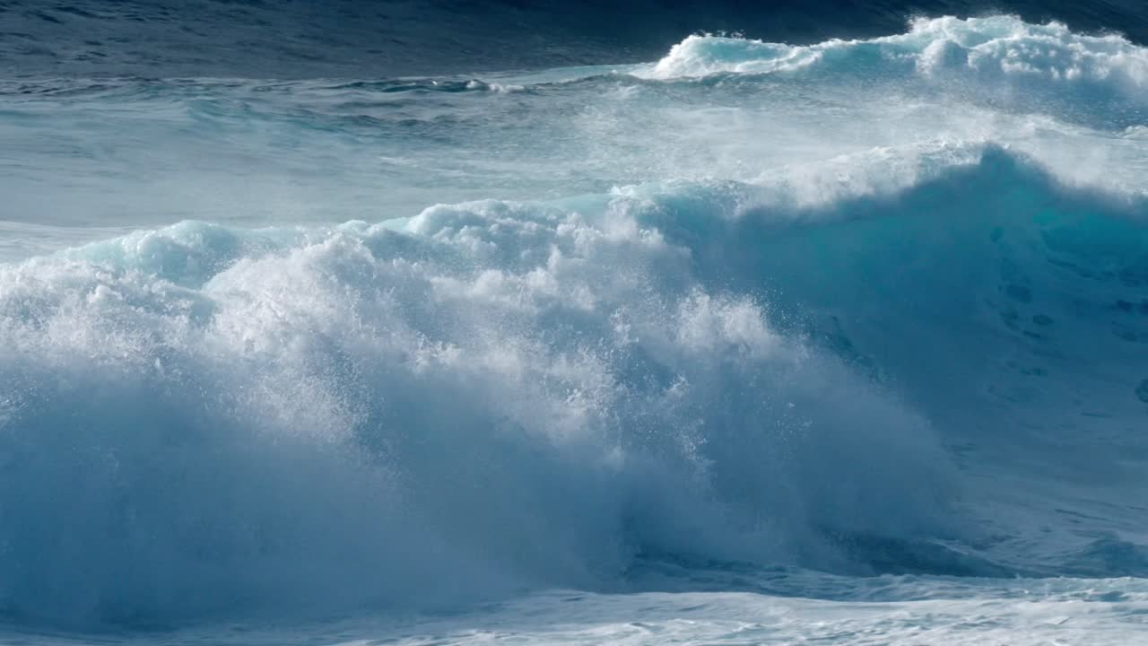 Dramatic ocean waves collide with the volcanic coastline near Timanfaya National Park, located on the island of Lanzarote in the Canary Islands, Spain.