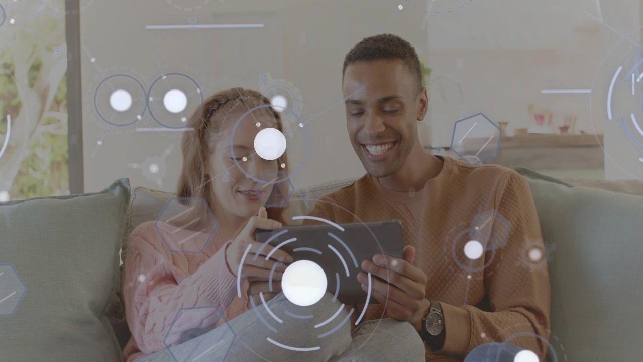 Couple tapping tablet starting content for sharing, woman leaning on man while HUD icons appearing