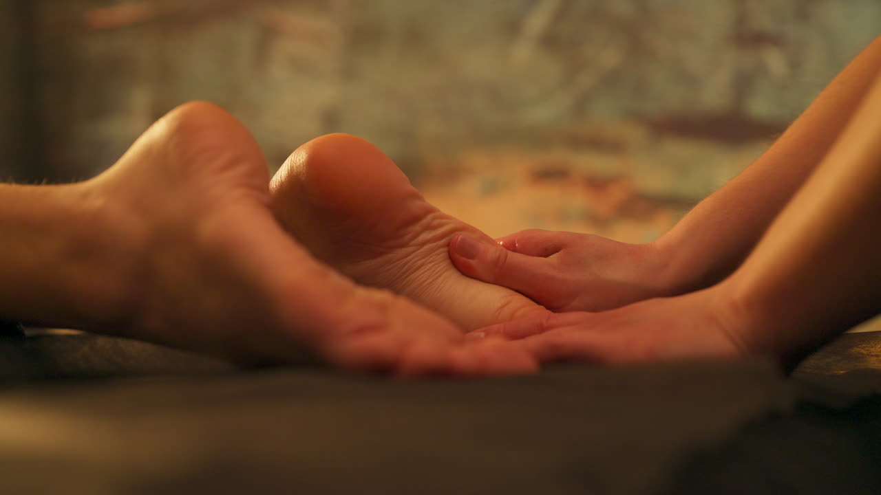 Masseuse Hands Massaging Clients Feet Sole. - closeup shot