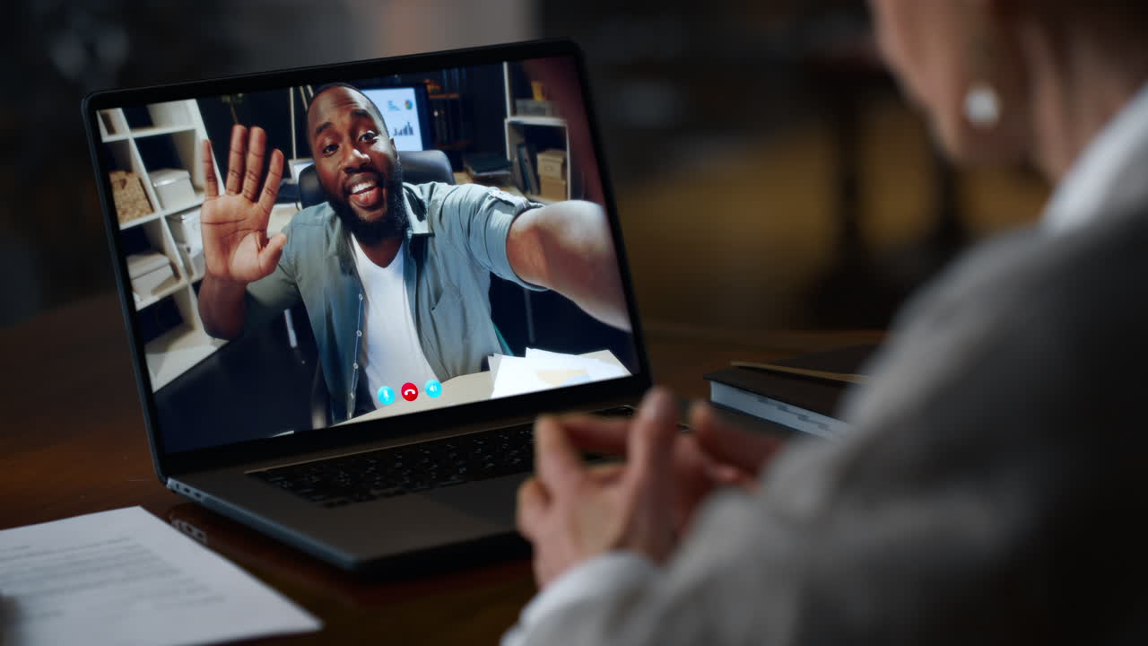 A video call between two people on a laptop